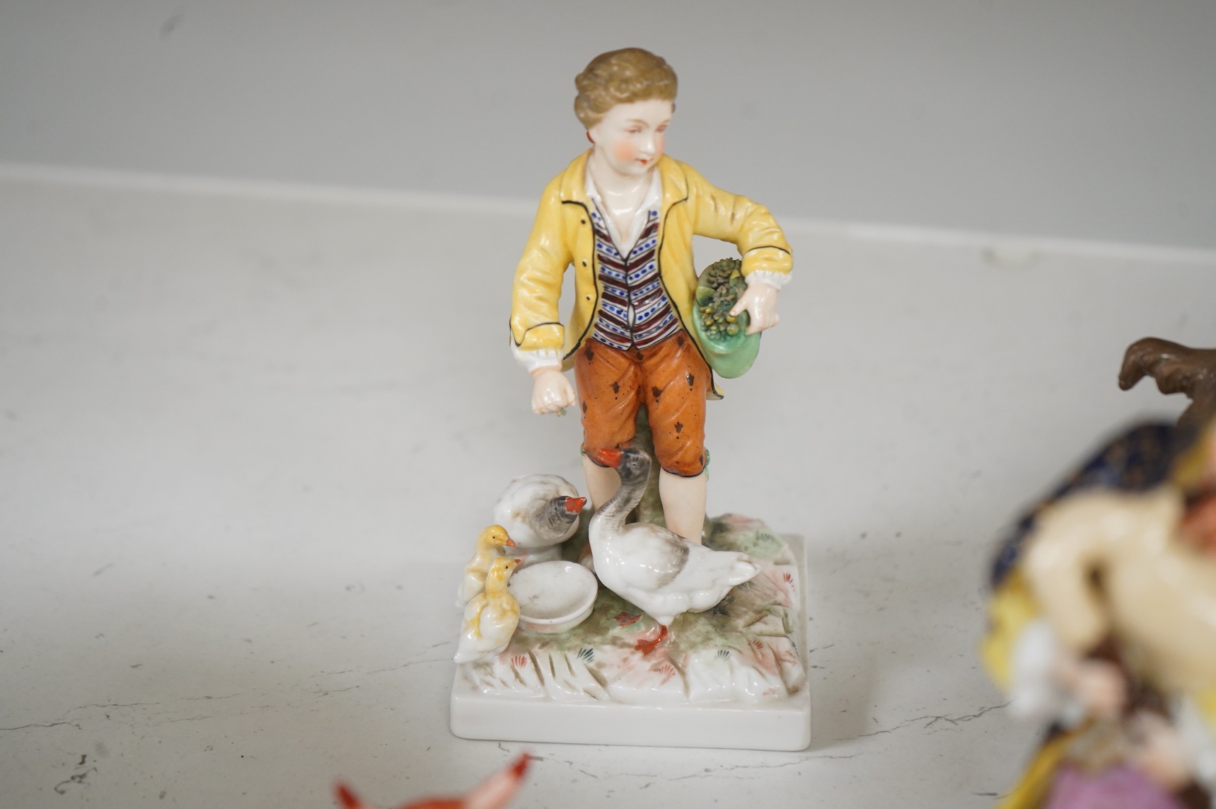 Two Derby porcelain seated figures emblematic of summer and autumn and a collection of Continental porcelain figures to include a pair of recumbent cows, largest 18cm high